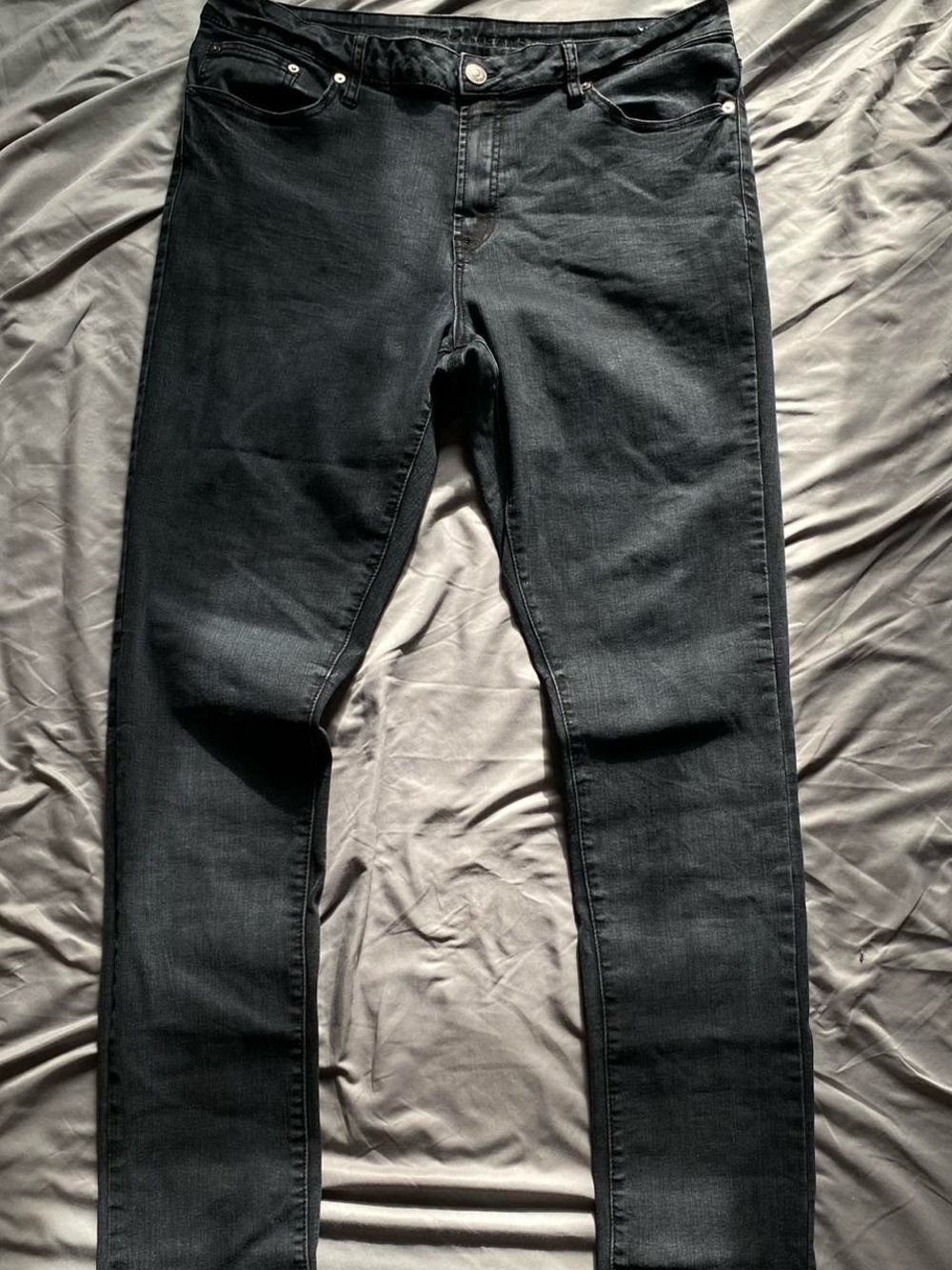 Faded black stacked skinny jeans with a stretchy fit